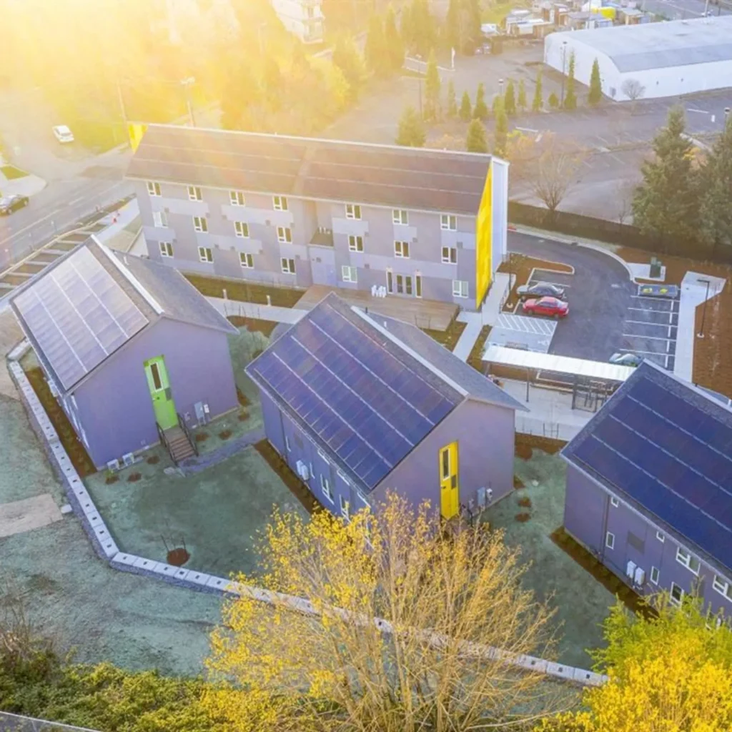 Aerial view of the Argyle Gardens community with solar-paneled cottages and apartment building