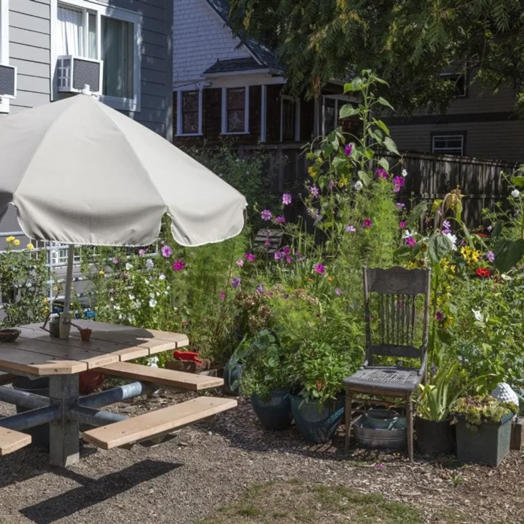 Community garden picnic table with umbrella at Barbara Maher Apartments